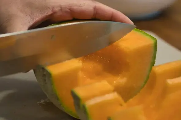 Slicing Cantaloupe In Cubes With A Knife